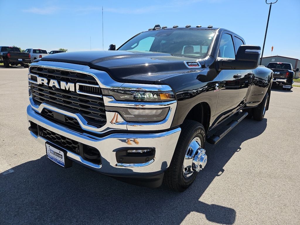2026 RAM 3500 RAM 3500 TRADESMAN CREW CAB 4X4 8' BOX in Diamond Black Crystal Pearl-Coat Exterior Paint — front three-quarter view